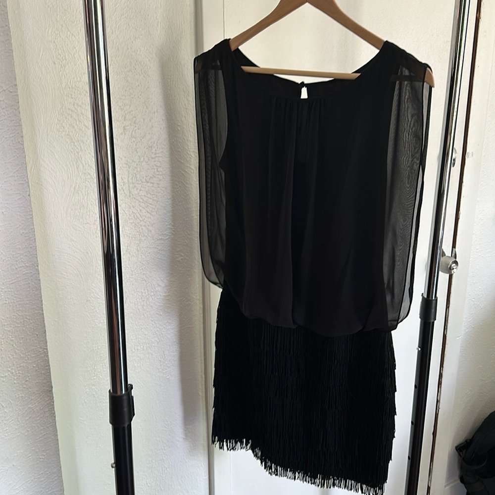 Black party dress with tassel bottom and shiffon top.